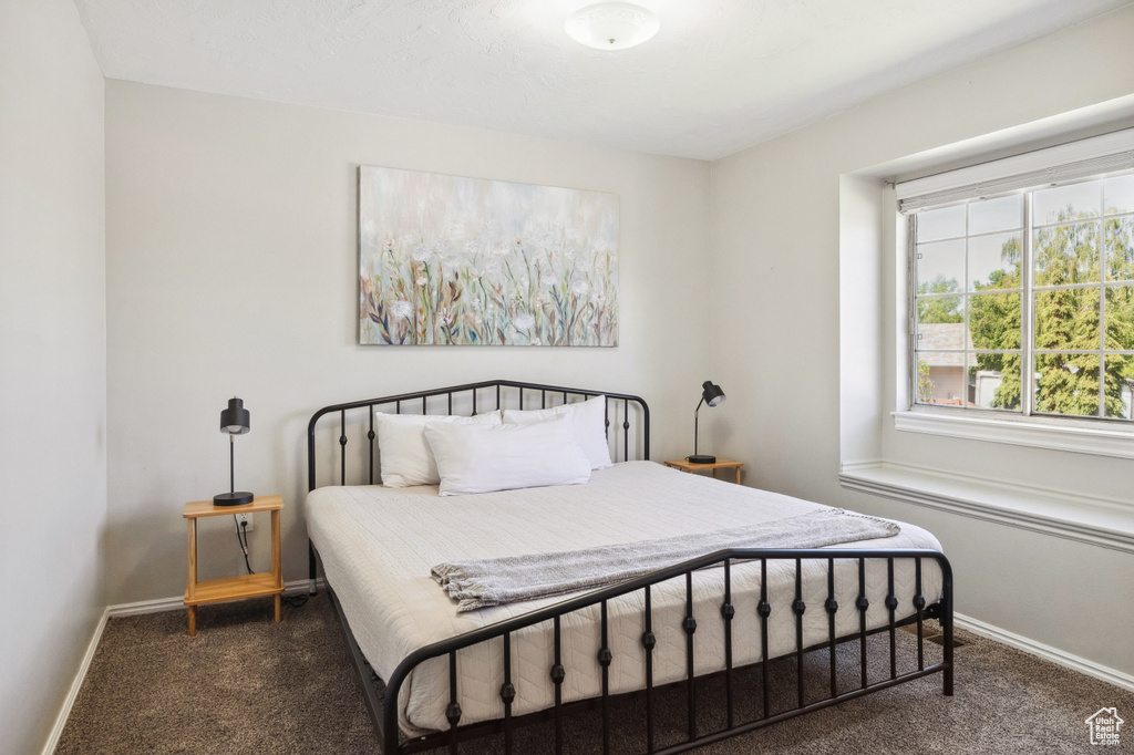 Carpeted bedroom featuring baseboards