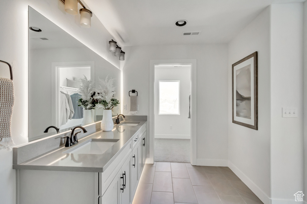 Full bathroom featuring double vanity and tile patterned floors