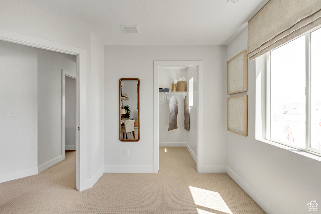 Unfurnished room with light colored carpet