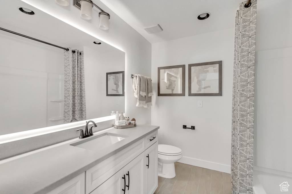 Full bath featuring vanity, a shower with curtain, and wood finished floors