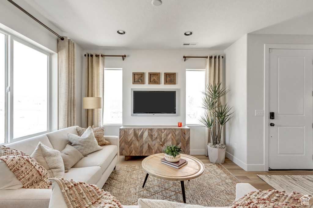 Living area featuring wood finished floors and recessed lighting