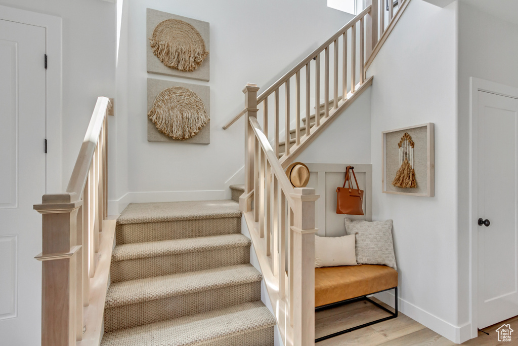 Staircase featuring baseboards and wood finished floors