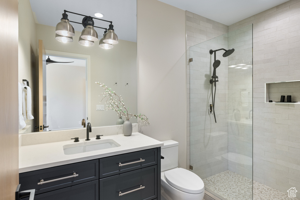 Full bath with vanity and a tile shower