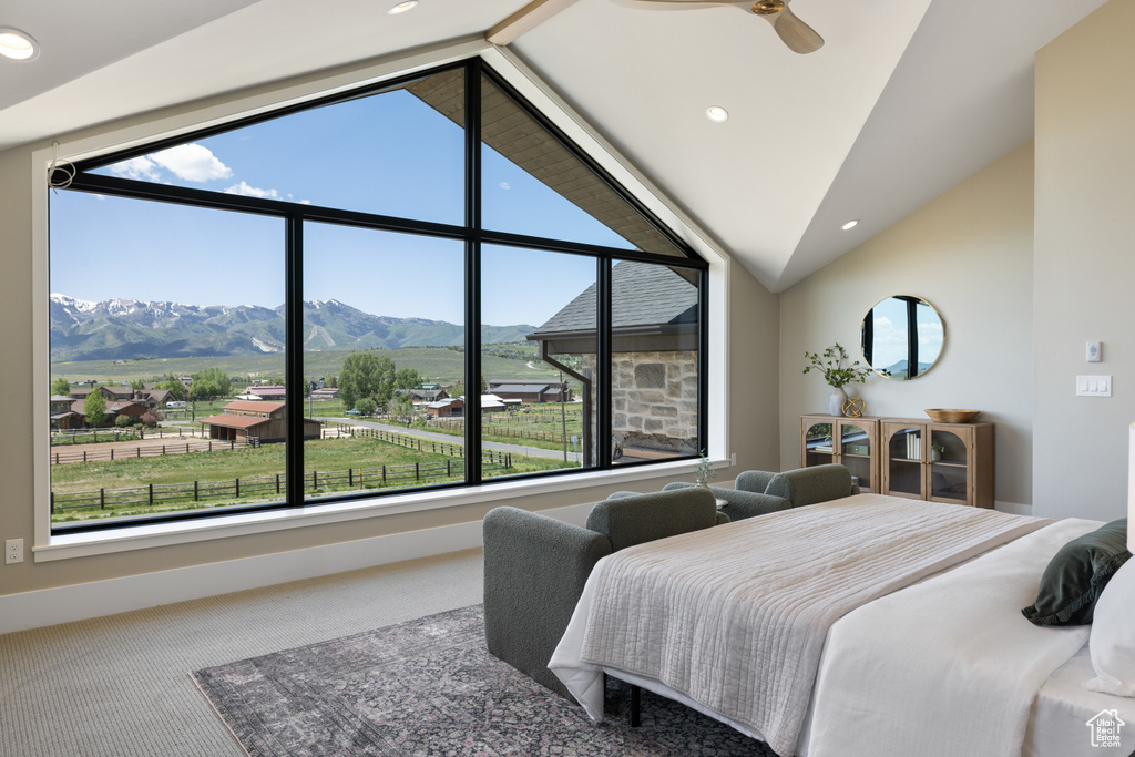 Carpeted bedroom featuring a mountain view, multiple windows, vaulted ceiling, and recessed lighting
