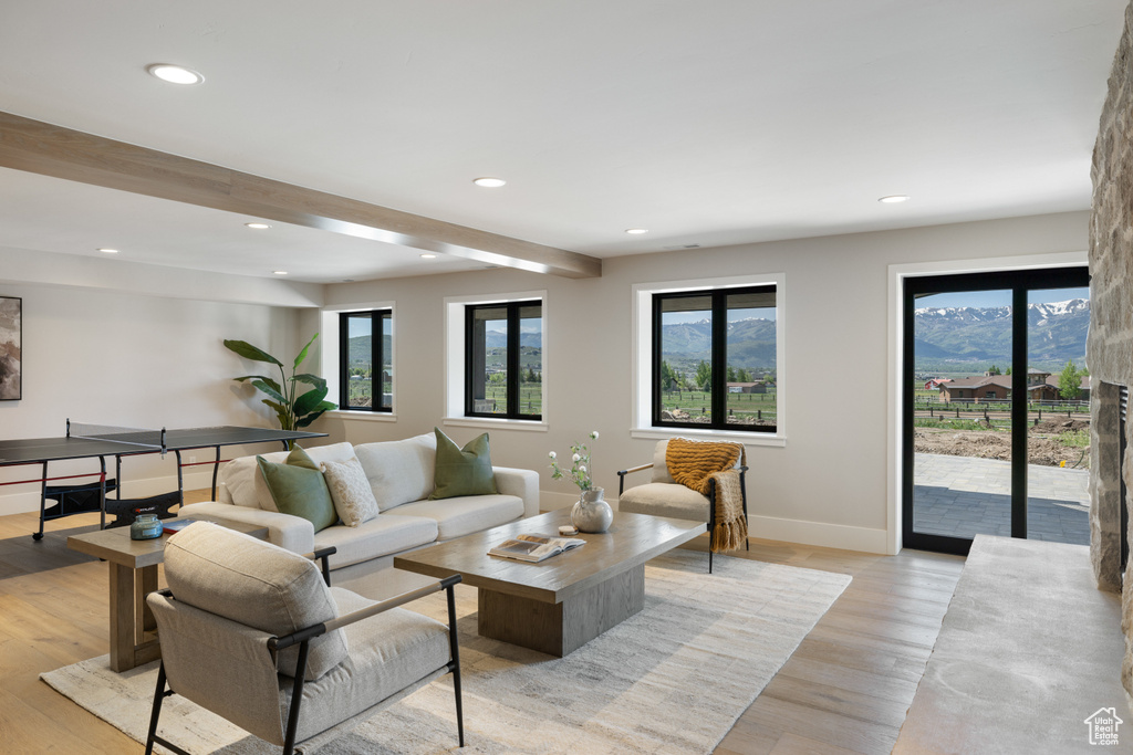 Living room with recessed lighting and light wood-style floors