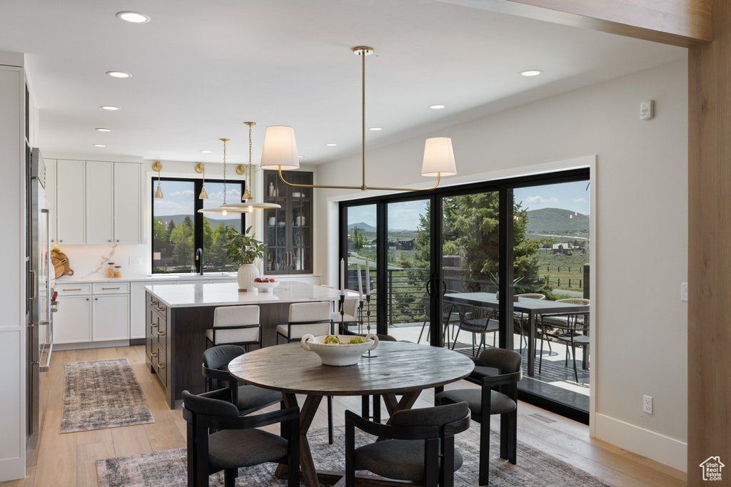 Dining room featuring light wood finished floors and recessed lighting