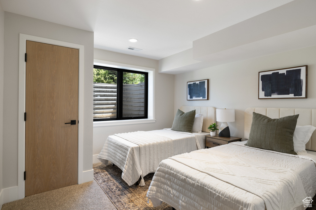 Carpeted bedroom with recessed lighting