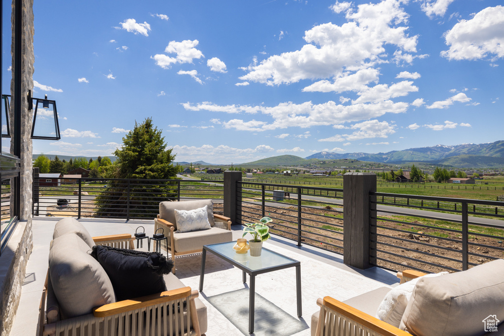 Patio / terrace with outdoor lounge area, a view of countryside, and a mountain view