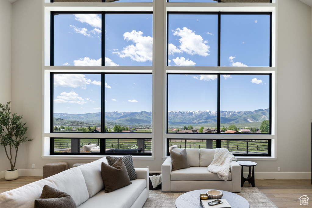 Living room with wood finished floors, plenty of natural light, and a mountain view