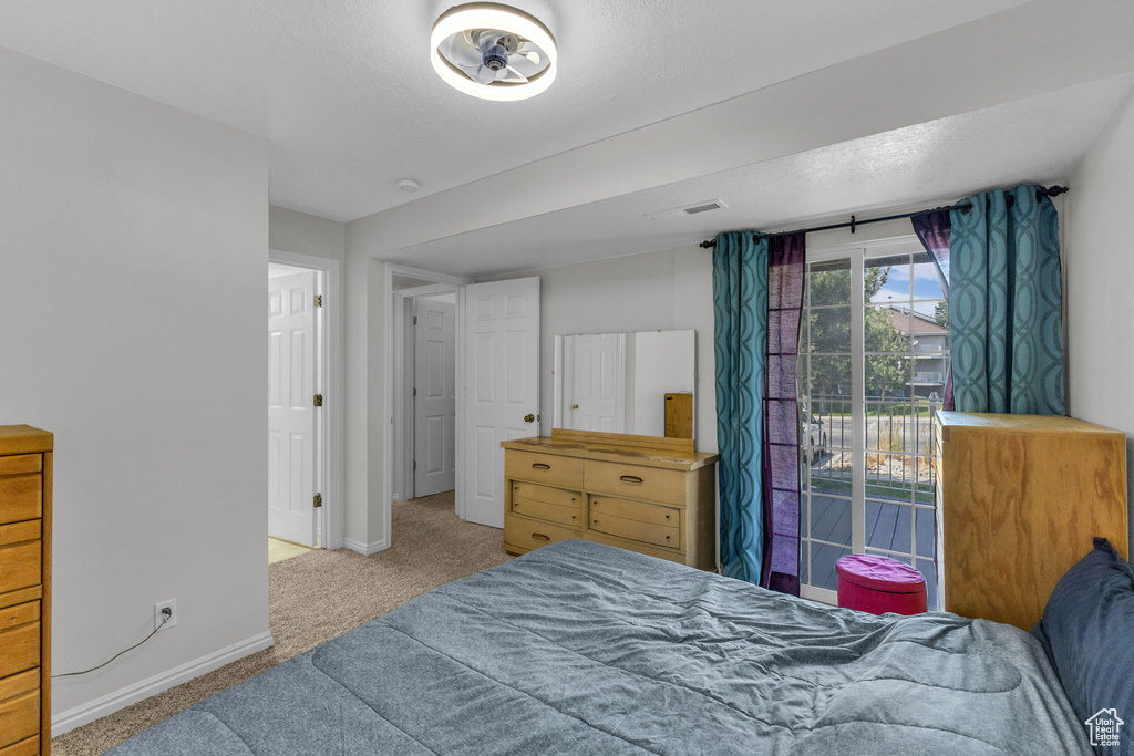 Bedroom featuring carpet flooring and access to outside