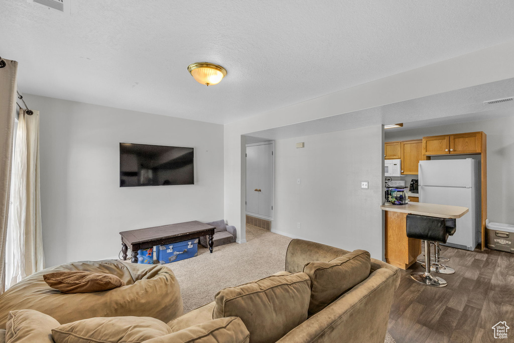 Living area featuring healthy amount of natural light and dark wood-type flooring
