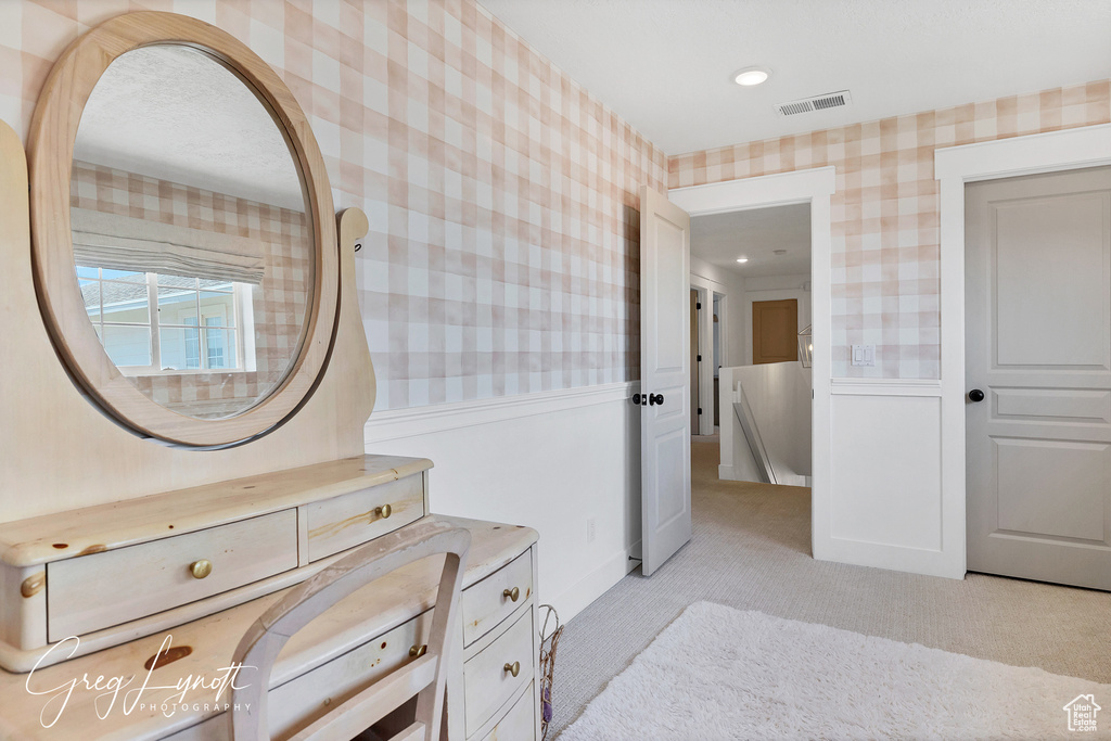 Bathroom featuring wallpapered walls, vanity, and recessed lighting