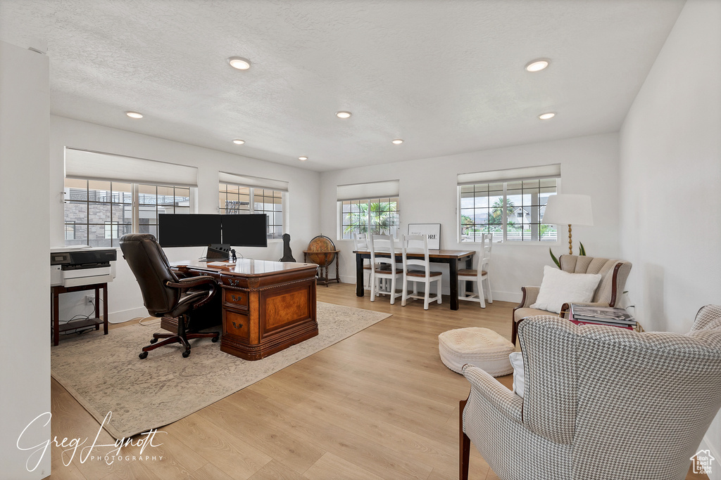 Office area featuring wood finished floors and recessed lighting