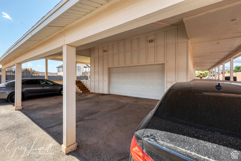 Garage with a carport and driveway