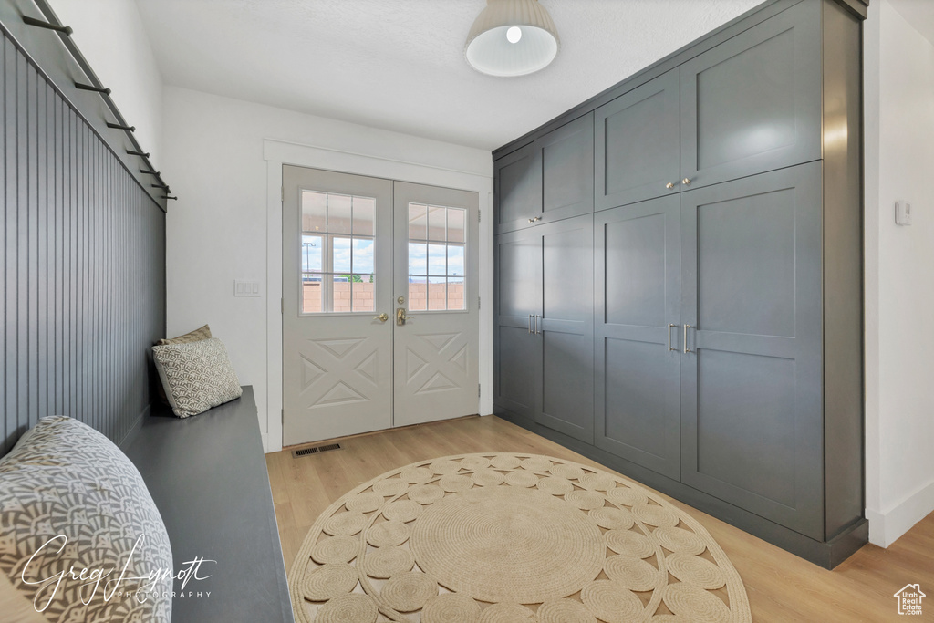 Mudroom featuring light wood-type flooring and french doors