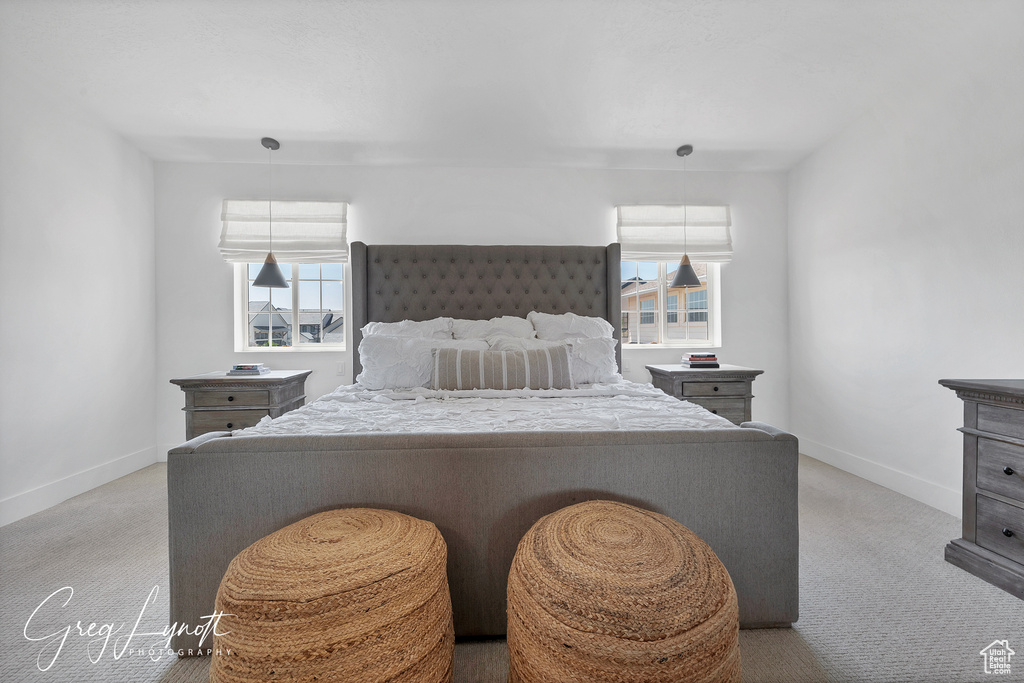 Carpeted bedroom featuring baseboards