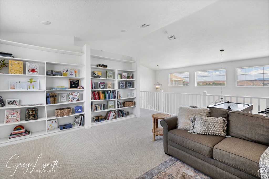 Living room with vaulted ceiling and carpet