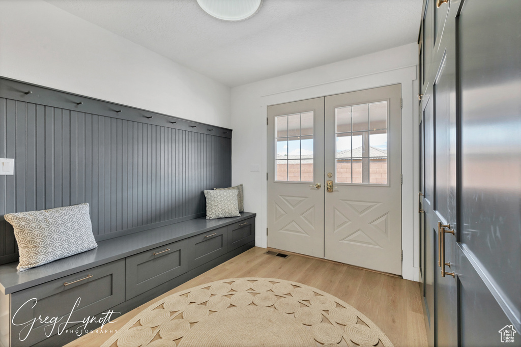 Mudroom featuring french doors and light wood-type flooring