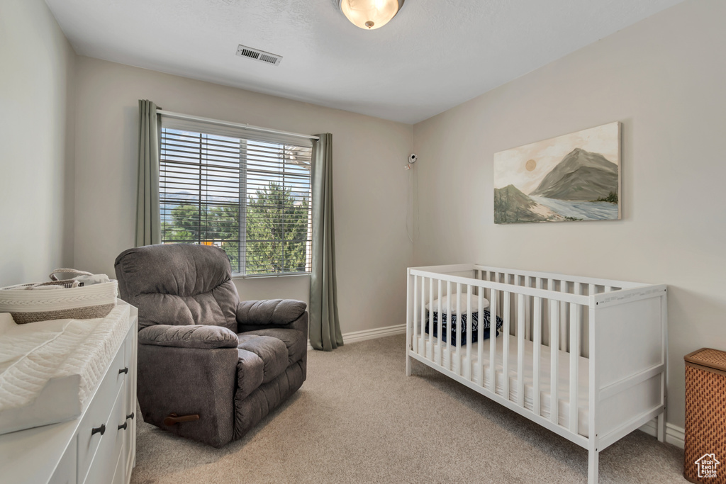 Bedroom with light colored carpet