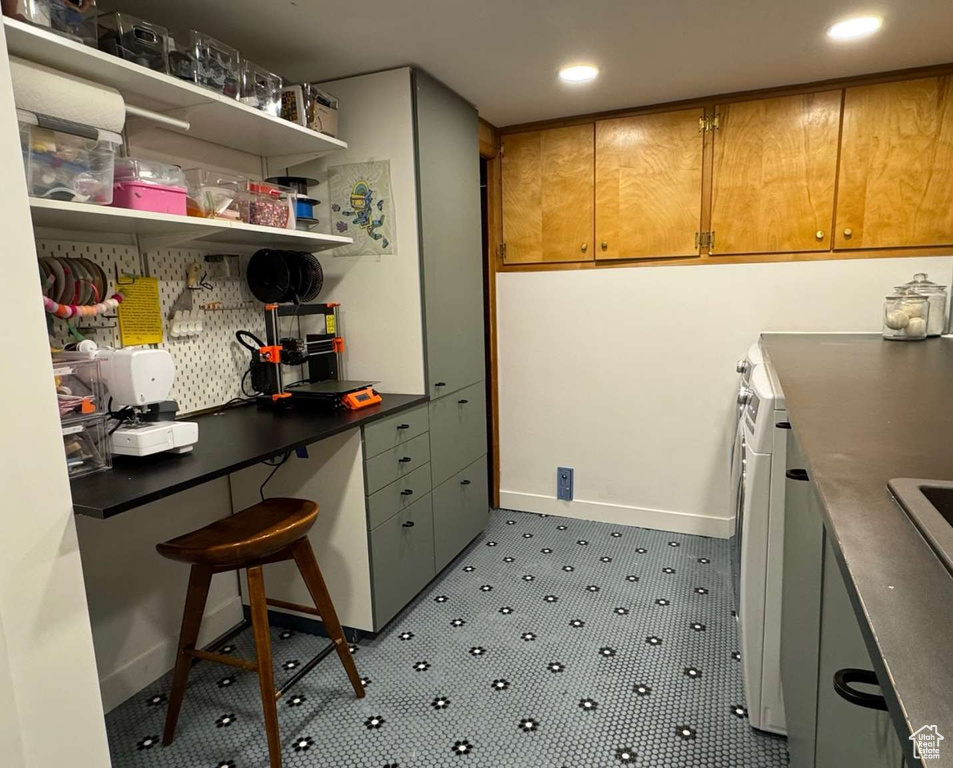Kitchen with recessed lighting, open shelves, a desk, and dark countertops