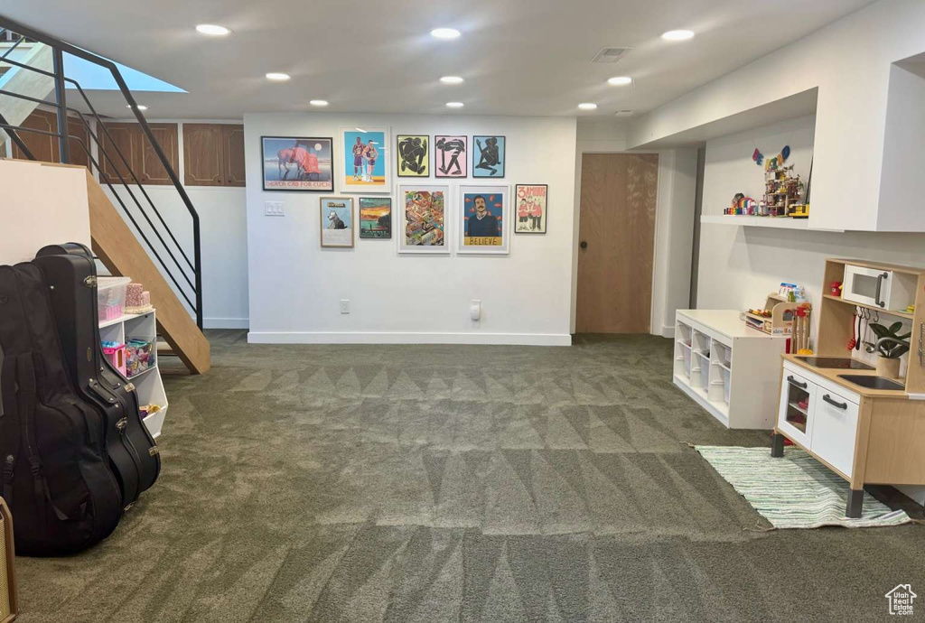 Playroom with carpet floors and recessed lighting
