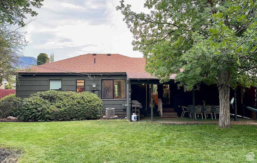 Rear view of property featuring a lawn