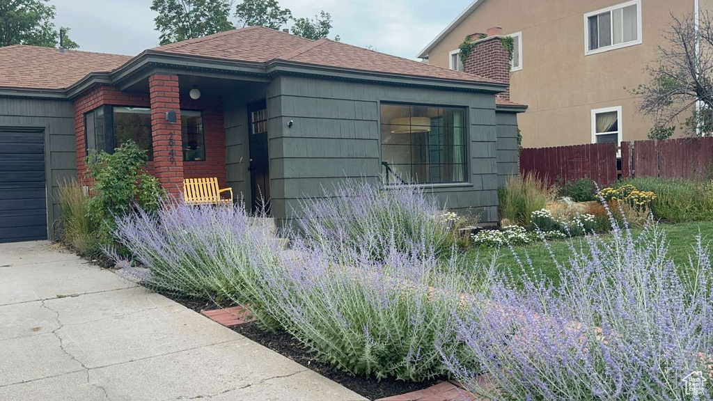View of side of home featuring a shingled roof