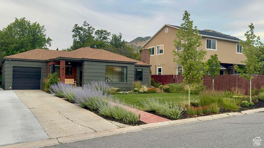 View of front facade featuring a garage and concrete driveway