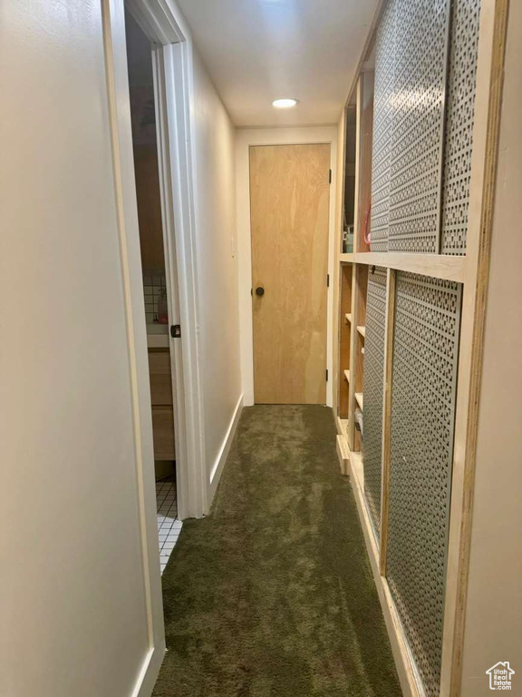 Corridor featuring carpet flooring and baseboards