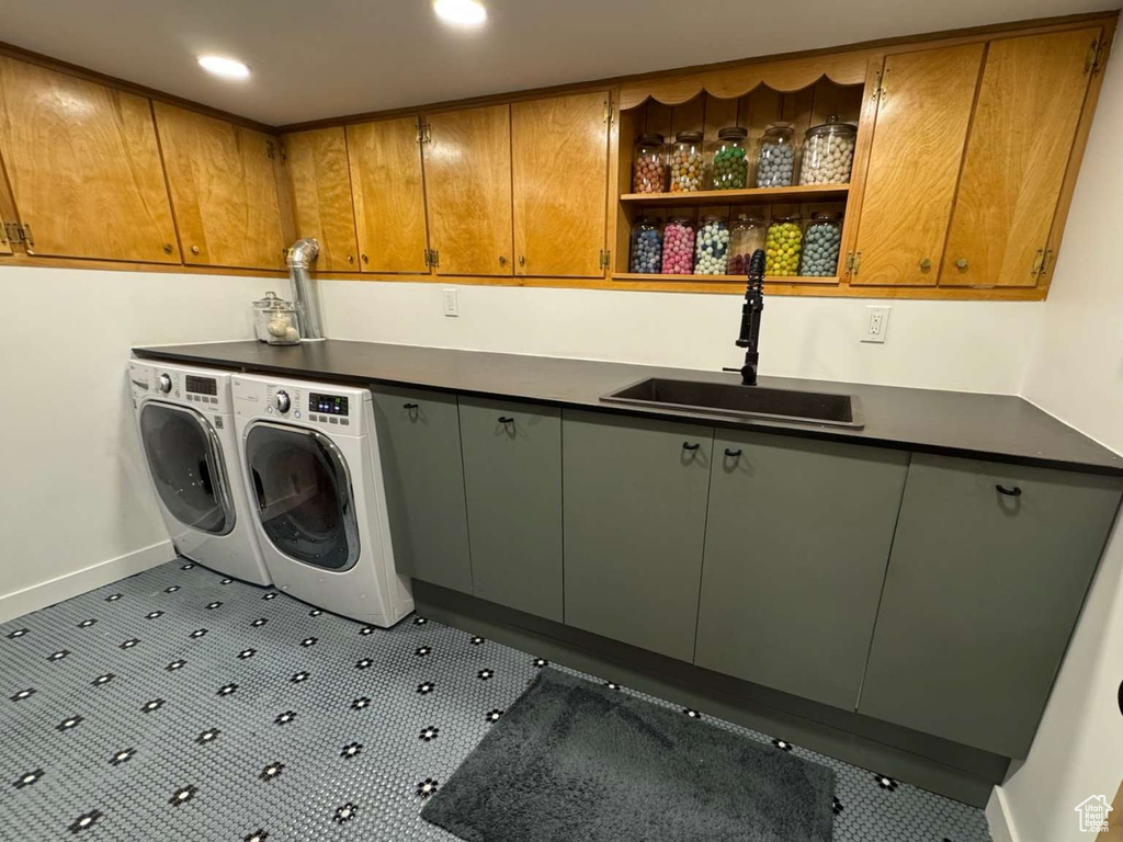 Washroom featuring cabinet space, washer and clothes dryer, and recessed lighting