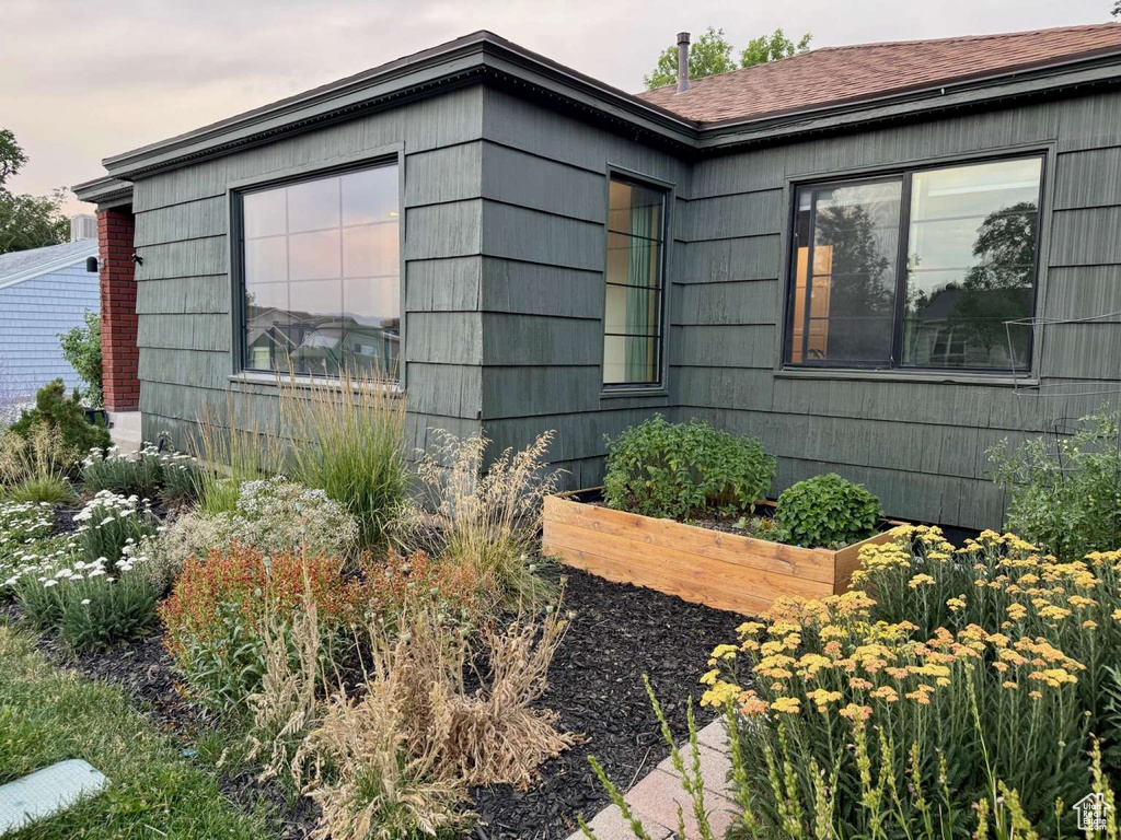 View of property exterior featuring a vegetable garden