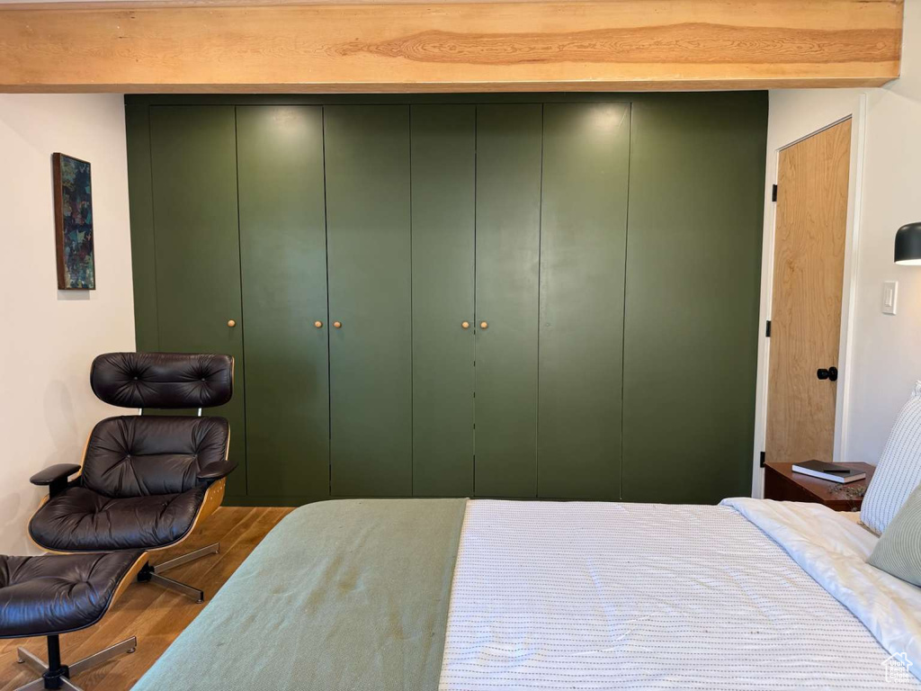 Bedroom featuring wood finished floors and a closet