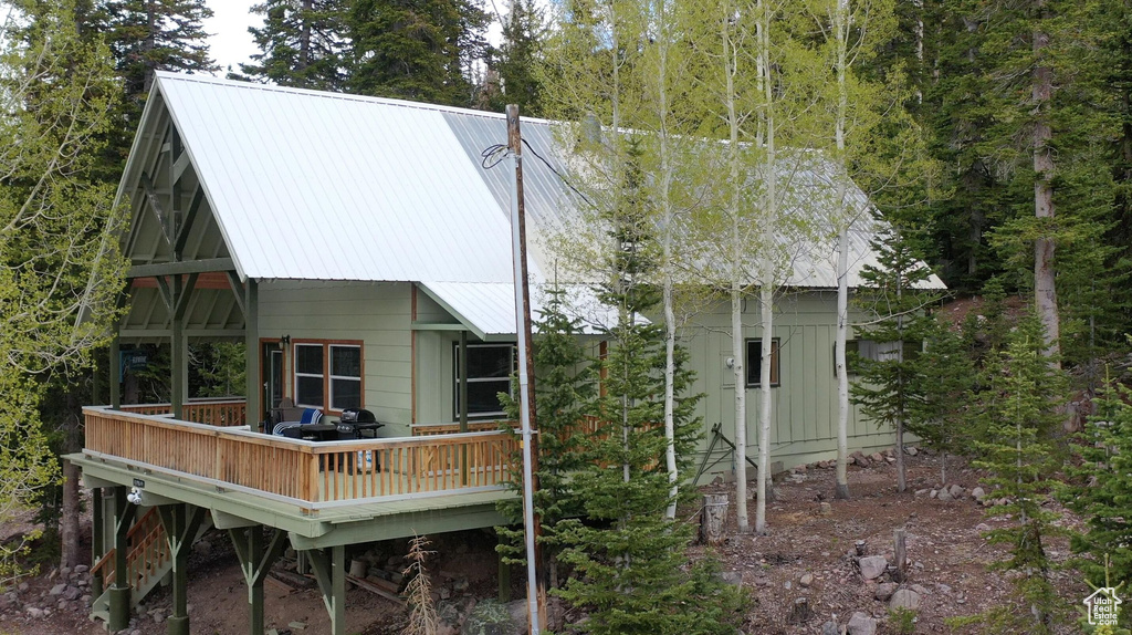 Back of property with a deck and a metal roof