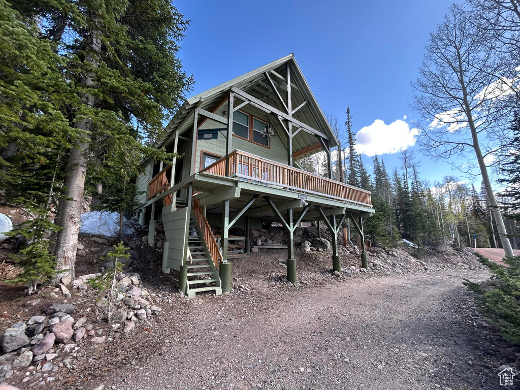 View of front of house featuring stairs and a deck
