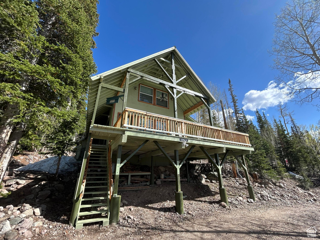 View of front of home featuring stairs and a deck