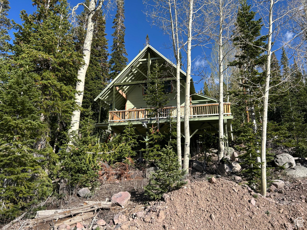 View of side of home featuring a wooden deck