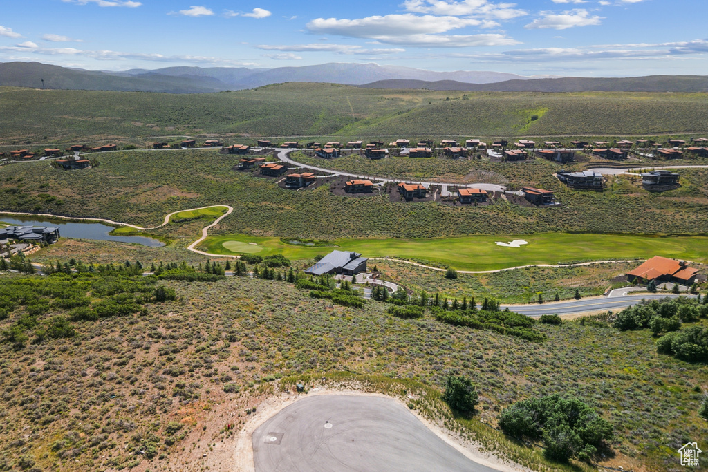 Drone / aerial view of a water and mountain view and a golf course