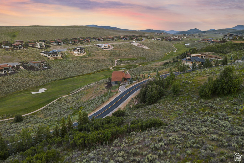 View of property location featuring a mountain backdrop and a golf course