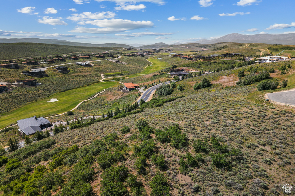 Drone / aerial view of a mountain backdrop and a golf club