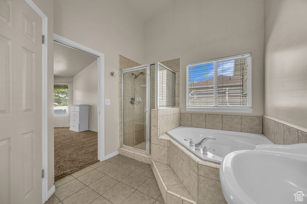 Bathroom featuring a whirlpool tub, a shower stall, and tile patterned floors