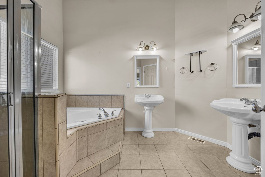 Bathroom featuring a garden tub and tile patterned floors