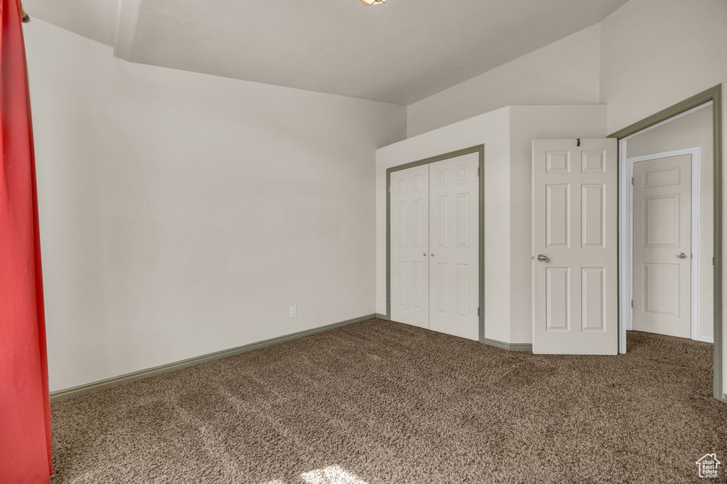 Unfurnished bedroom featuring carpet and a closet