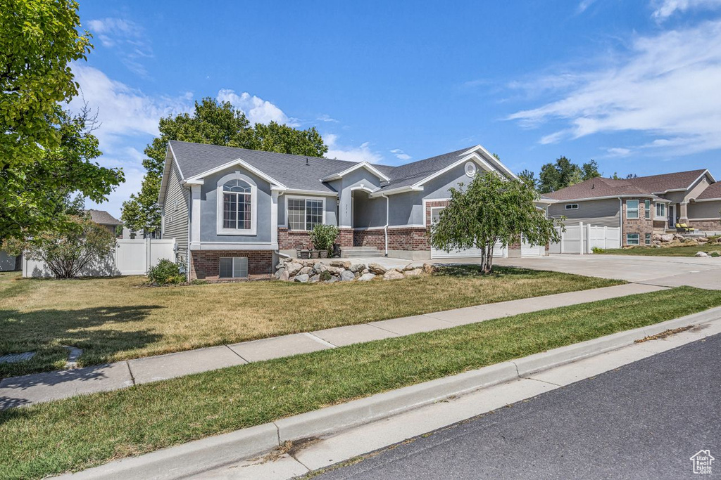 Ranch-style house featuring brick siding, driveway, and a garage