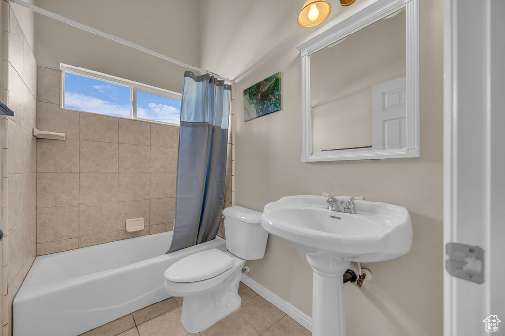Bathroom featuring tile patterned floors and shower / bathtub combination with curtain
