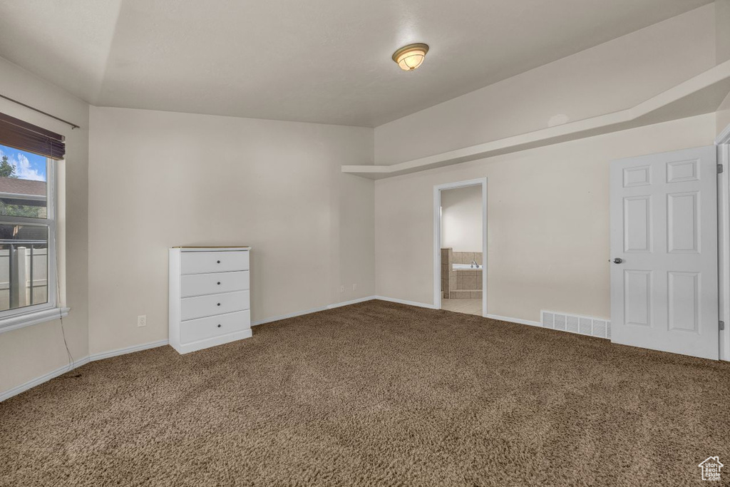 Carpeted empty room with baseboards