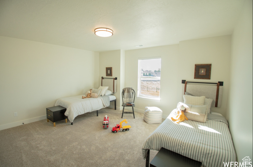 Carpeted bedroom featuring baseboards