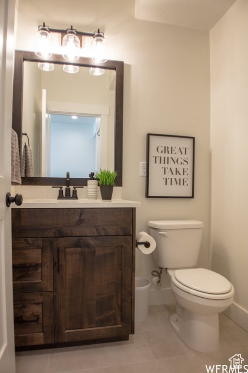 Half bath featuring vanity and tile patterned flooring