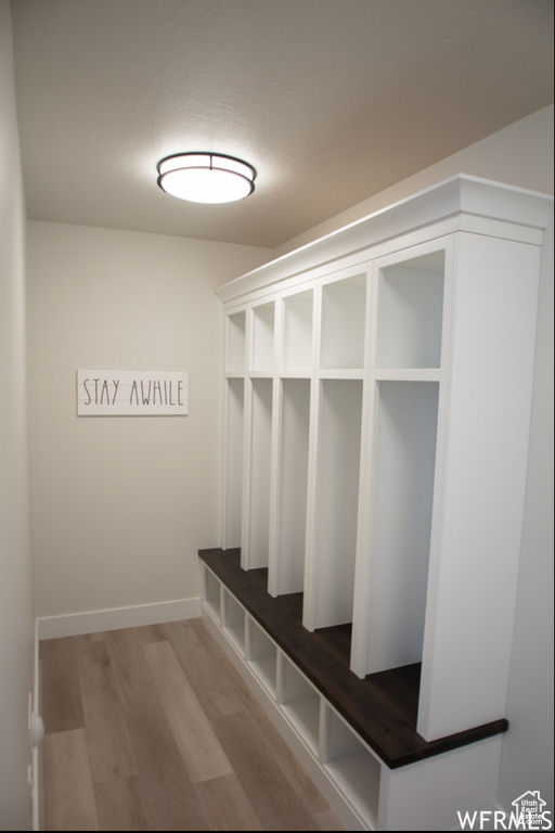 Mudroom featuring wood finished floors and baseboards