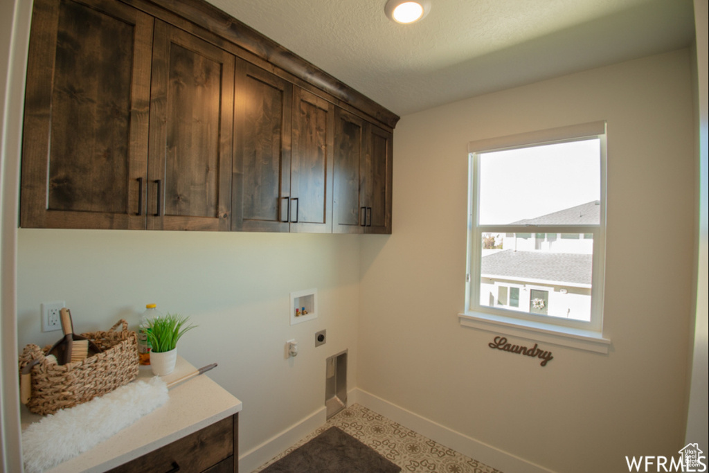 Laundry room with cabinet space, electric dryer hookup, and hookup for a washing machine