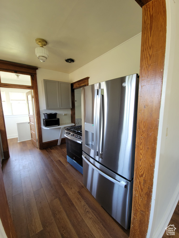 Kitchen with appliances with stainless steel finishes, dark wood-style floors, light countertops, and gray cabinets
